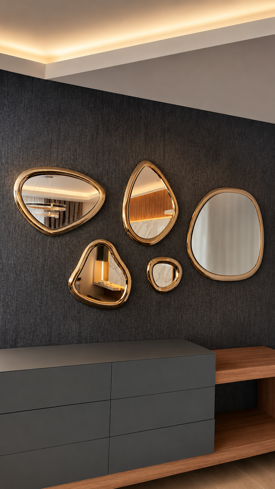 Set of five organic-shaped mirrors with polished gold frames arranged on a dark textured wall above modern cabinetry.
