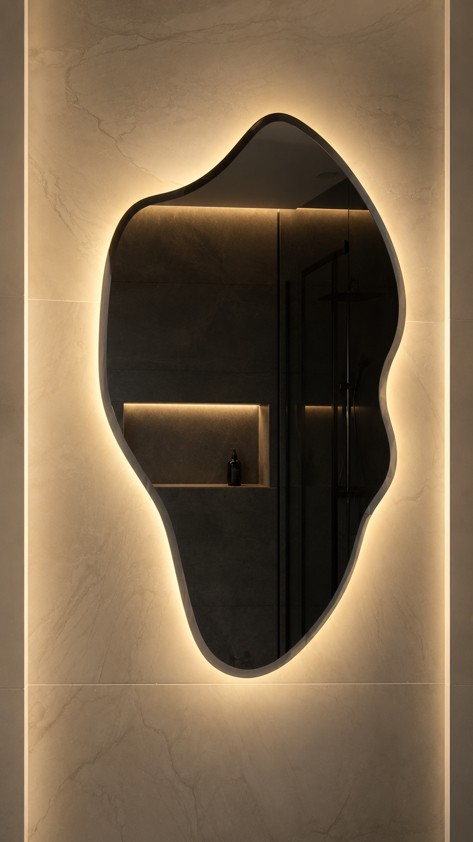 Asymmetrical dark-tinted bathroom mirror with warm LED backlighting mounted on a marble-look wall.